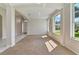 Bright living room with large windows, carpeted floors, and decorative archways to the entry and dining at 1746 Golfview Dr, Kissimmee, FL 34746