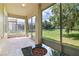 Covered patio with tiled floor and a beautiful view of the well maintained, large grassy yard at 1746 Golfview Dr, Kissimmee, FL 34746