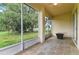 Covered patio with slate flooring and a beautiful view of the lush green yard at 1746 Golfview Dr, Kissimmee, FL 34746