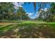 Expansive yard with mature trees and green grass at 1746 Golfview Dr, Kissimmee, FL 34746