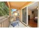 This is a balcony with chairs, a table and view of adjacent townhomes at 203 La Mirage St, Davenport, FL 33897