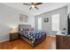 This bedroom offers wood floors, a ceiling fan, and natural light from the windows at 203 La Mirage St, Davenport, FL 33897
