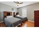 Bedroom with wood floors, a ceiling fan, two twin beds with built-in bookshelves at 203 La Mirage St, Davenport, FL 33897