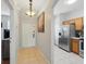 Hallway leading to front door and kitchen featuring tile flooring at 203 La Mirage St, Davenport, FL 33897