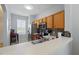 Bright kitchen with wood cabinetry, stainless steel appliances, and a breakfast bar area at 203 La Mirage St, Davenport, FL 33897