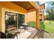Outdoor patio area with table and chairs, accessible from the home with sliding glass doors at 203 La Mirage St, Davenport, FL 33897