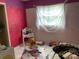 ' bedroom with a magenta accent wall and playful decor at 2329 W Doris St, Kissimmee, FL 34741