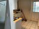 The kitchen with classic tile floors, a vintage door, and awaiting a modern update at 2329 W Doris St, Kissimmee, FL 34741