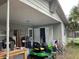 Rear exterior featuring lawn equipment, storage, and access to the home's backyard at 2329 W Doris St, Kissimmee, FL 34741