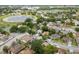 Overhead view of a quiet residential neighborhood featuring community lakes and mature trees at 2421 Deermeadow Dr, Apopka, FL 32703