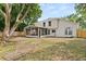Exterior shot of the home featuring the screened-in back patio and fenced backyard at 2421 Deermeadow Dr, Apopka, FL 32703