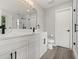 Bright bathroom with double vanity, tiled walk in shower, and modern fixtures at 2421 Deermeadow Dr, Apopka, FL 32703