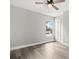 Bright bedroom features wood-look flooring, a ceiling fan and a view to the exterior at 2421 Deermeadow Dr, Apopka, FL 32703