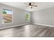 Spacious bedroom with wood flooring, neutral paint, and two windows providing ample natural light at 2421 Deermeadow Dr, Apopka, FL 32703