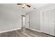 Bedroom with hard surface floors, ceiling fan, and a double-door closet and bathroom access at 2421 Deermeadow Dr, Apopka, FL 32703