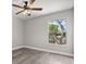 Cozy bedroom featuring wood-look flooring, a ceiling fan and a view to the exterior at 2421 Deermeadow Dr, Apopka, FL 32703