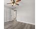 Bedroom with hard surface floors, ceiling fan, and a double-door closet and bathroom access at 2421 Deermeadow Dr, Apopka, FL 32703