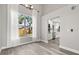 Bright dining area featuring wood floors, modern light fixture, and an open view of the adjacent updated kitchen at 2421 Deermeadow Dr, Apopka, FL 32703