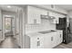 Modern kitchen featuring white cabinets, sleek appliances, and a stylish subway tile backsplash at 2421 Deermeadow Dr, Apopka, FL 32703