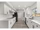 Modern white kitchen with stainless steel appliances, and sleek black hardware at 2421 Deermeadow Dr, Apopka, FL 32703