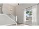 Bright living room with vaulted ceiling, large windows with sheer curtains, and staircase with white railing at 2421 Deermeadow Dr, Apopka, FL 32703
