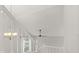 White staircase with a vaulted ceiling, ceiling fan, and modern lighting at 2421 Deermeadow Dr, Apopka, FL 32703