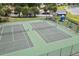 Aerial shot of community tennis courts, playground, and pond at 2421 Deermeadow Dr, Apopka, FL 32703