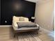 The bedroom showcases a sleek black accent wall, wood-look floors, and a comfortable bed at 2453 Sipes Ave, Sanford, FL 32771