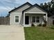Charming single-story home featuring a welcoming front porch and well-maintained lawn at 2453 Sipes Ave, Sanford, FL 32771