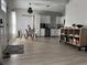 Bright living space featuring an open floor plan, modern decor, and stainless steel appliances in the kitchen at 2453 Sipes Ave, Sanford, FL 32771
