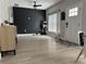 Open living space featuring wood-look floors and a black accent wall, providing a modern and stylish look at 2453 Sipes Ave, Sanford, FL 32771