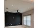 This living area boasts wood-look floors, a modern ceiling fan, and a striking black accent wall at 2453 Sipes Ave, Sanford, FL 32771