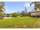 Large backyard with mature trees, and views of the lake at 248 Country Landing Blvd, Apopka, FL 32703