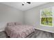 Bedroom with a ceiling fan, window overlooking the lake and gray wood floors at 248 Country Landing Blvd, Apopka, FL 32703