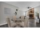 Dining area featuring a round glass table with chairs next to a living area with a fireplace at 248 Country Landing Blvd, Apopka, FL 32703