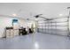 Spacious two-car garage with white walls, blue floor and ample space for storage and parking at 248 Country Landing Blvd, Apopka, FL 32703