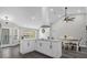 Bright open kitchen features a large island with white cabinets and a dining area with a table and chairs at 248 Country Landing Blvd, Apopka, FL 32703