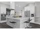 Modern kitchen with a large marble island, stainless steel appliances and stylish bar stool seating at 248 Country Landing Blvd, Apopka, FL 32703