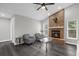 Cozy living room with a charming brick fireplace, stylish furniture, and plenty of natural light at 248 Country Landing Blvd, Apopka, FL 32703