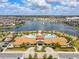 Community clubhouse featuring a pool, lake with fountain, and beautiful landscaping at 2547 Trielle Ave, Kissimmee, FL 34741