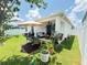 Spacious backyard with a well-maintained lawn, patio, and outdoor furniture at 2547 Trielle Ave, Kissimmee, FL 34741