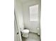 Clean half bathroom with modern fixtures, tile flooring, and a window at 2547 Trielle Ave, Kissimmee, FL 34741