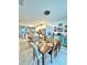Open-concept dining area with a wooden table, adjacent to the kitchen and bright natural light at 2547 Trielle Ave, Kissimmee, FL 34741