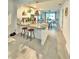 Open concept kitchen with a breakfast bar, pendant lighting, white cabinets, and tile flooring at 2547 Trielle Ave, Kissimmee, FL 34741