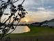 Scenic lake view at sunset, with golden light reflecting on the water's surface at 2547 Trielle Ave, Kissimmee, FL 34741
