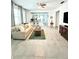 Bright living room boasts an open floor plan and neutral tones, complemented by stylish furnishings and tiled floors at 2547 Trielle Ave, Kissimmee, FL 34741