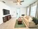 Cozy living room featuring neutral tones, a rustic coffee table, and large windows for natural light at 2547 Trielle Ave, Kissimmee, FL 34741