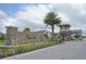 Community entrance sign with stone accents, lush landscaping, and inviting design at 2547 Trielle Ave, Kissimmee, FL 34741