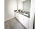 Modern main bathroom vanity with double sinks, granite countertops, and white cabinetry at 2547 Trielle Ave, Kissimmee, FL 34741