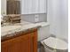 Modern bathroom with granite countertop, towel racks, neutral decor, and a shower with curtain at 2567 Oneida Loop, Kissimmee, FL 34747